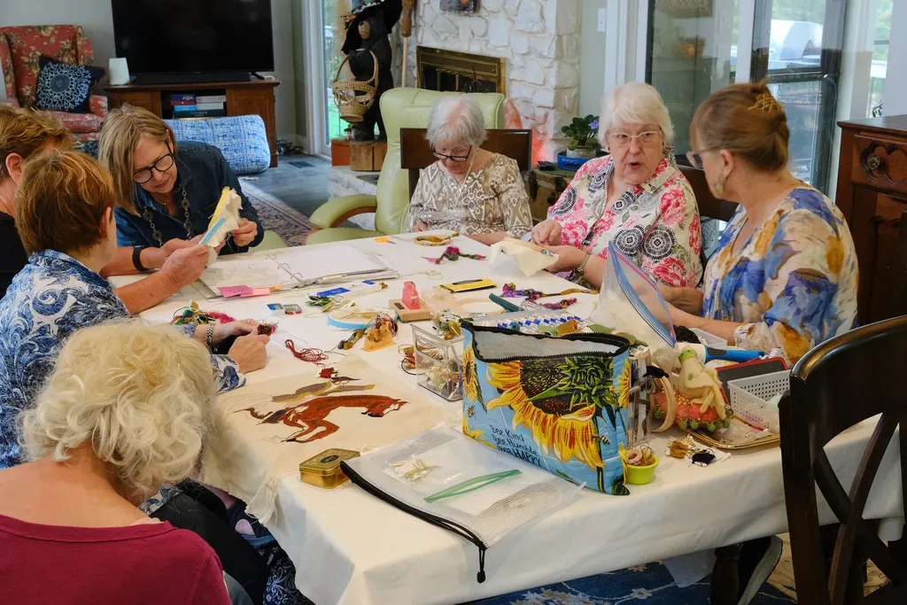 Karen's team stitching in her dining room - the project has outgrown her studio!