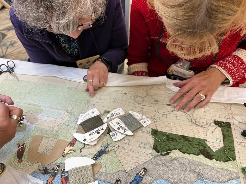 Embroiderers work on the New Hampshire panel