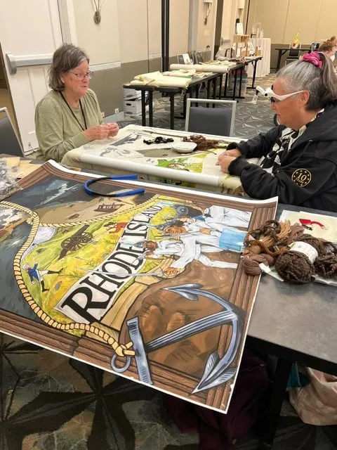 Volunteers take a stitch on the Rhode Island Panel